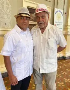 Two men in white shirts and hats.
