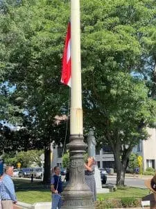 Woman raising a red and white flag.