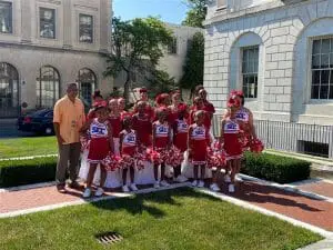 A group of young people standing in front of a building.