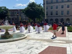 A group of people in red shirts and white bags.