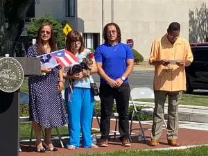 A group of people standing on the side walk