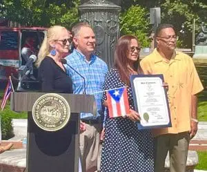 A group of people standing around a podium.