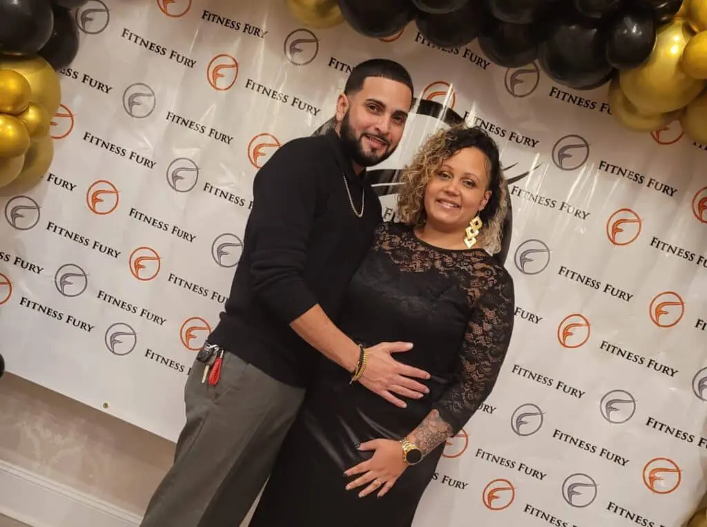 Couple posing in front of Fitness Fury logo.