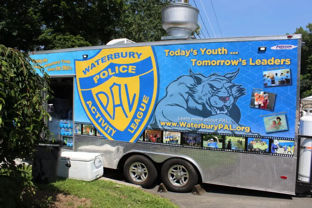 A blue and white trailer with a bear on it