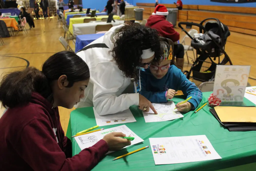 A woman and two children are sitting at a table.