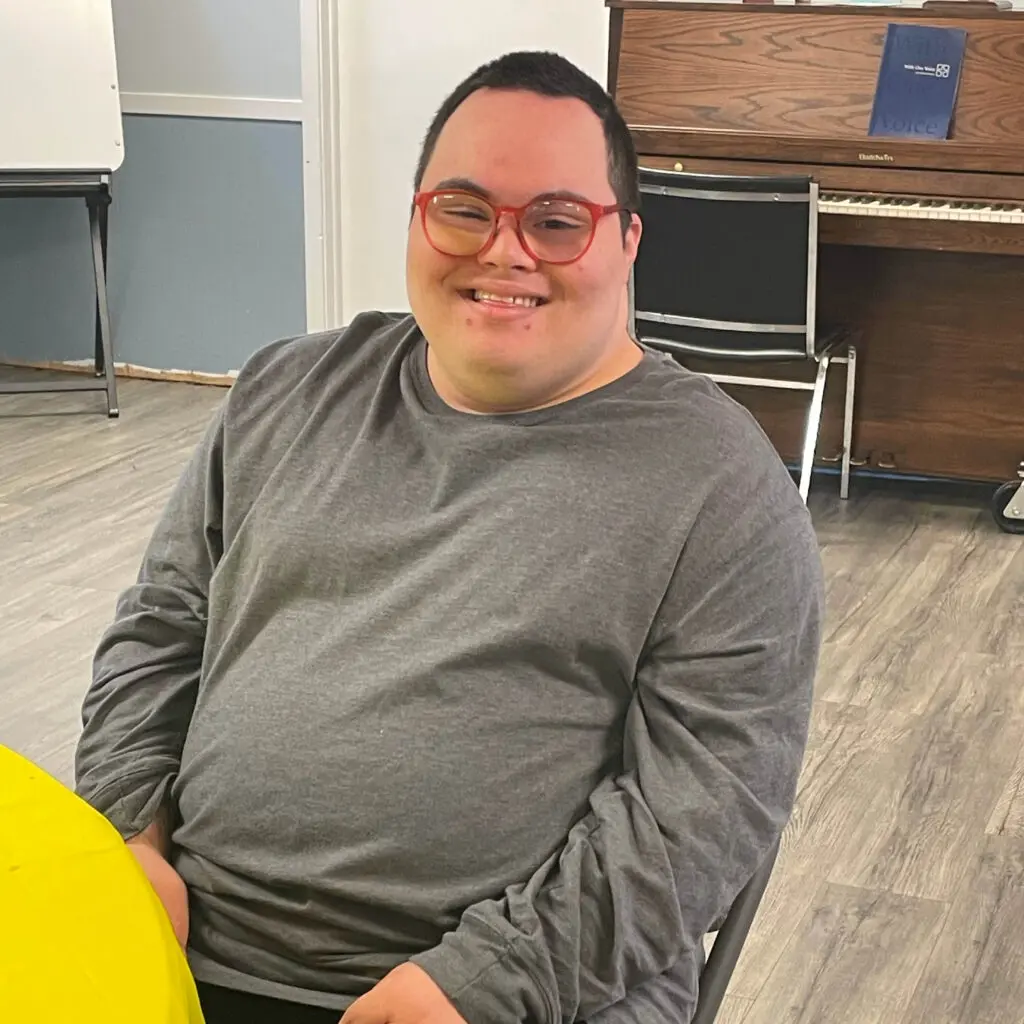 A man sitting in front of a piano.