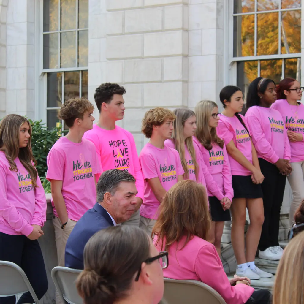 A group of people in pink shirts standing next to each other.