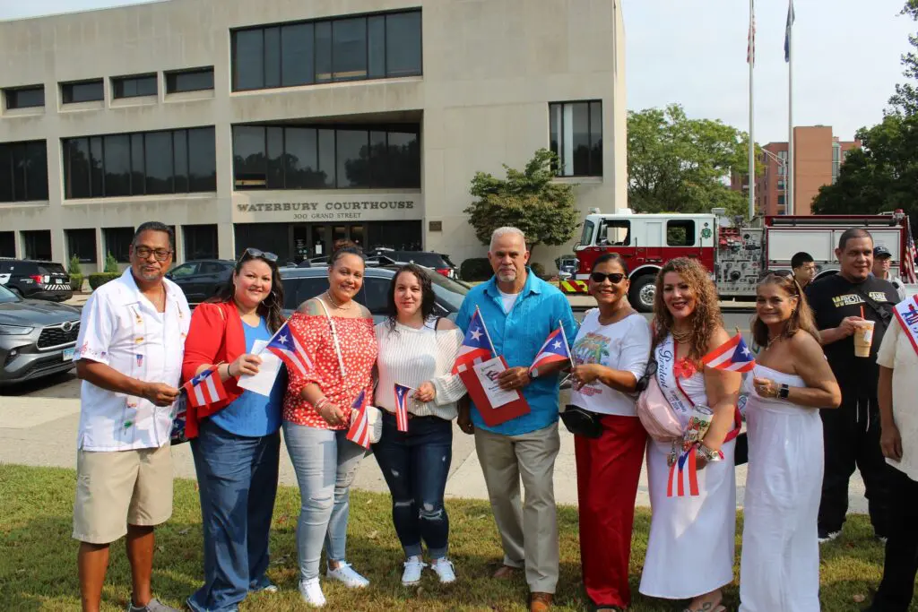 Group celebrating with flags outside courthouse.