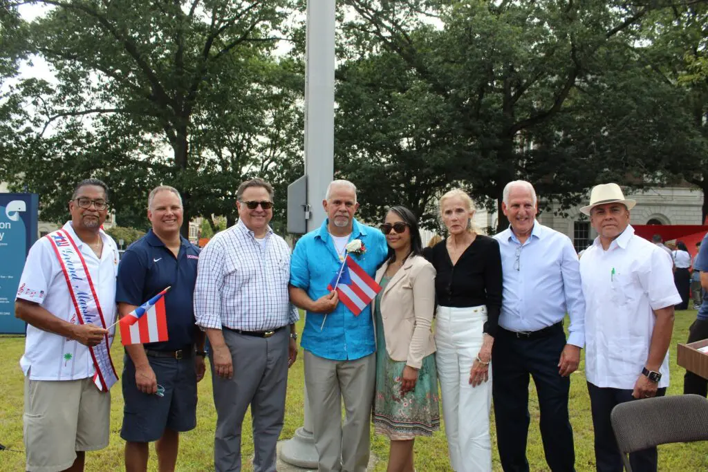 Group holding flags at outdoor event.
