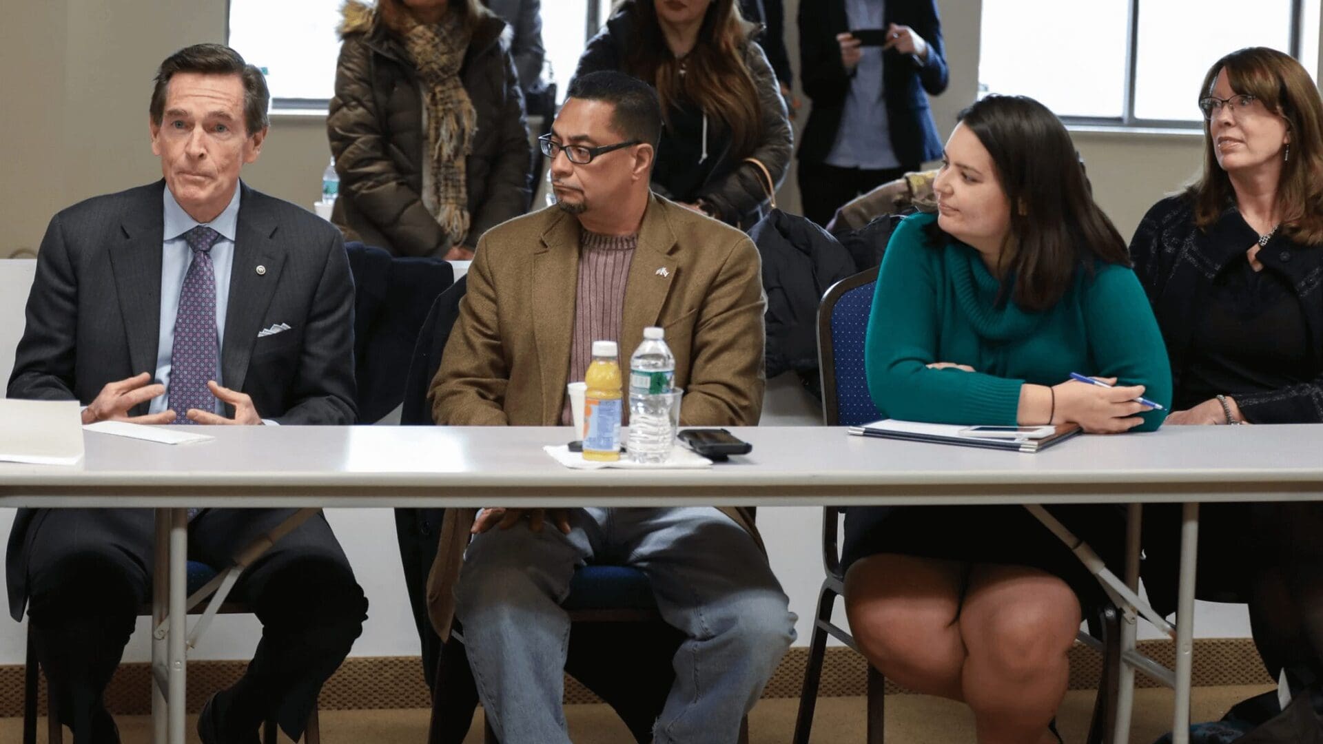 Four people seated at a table.