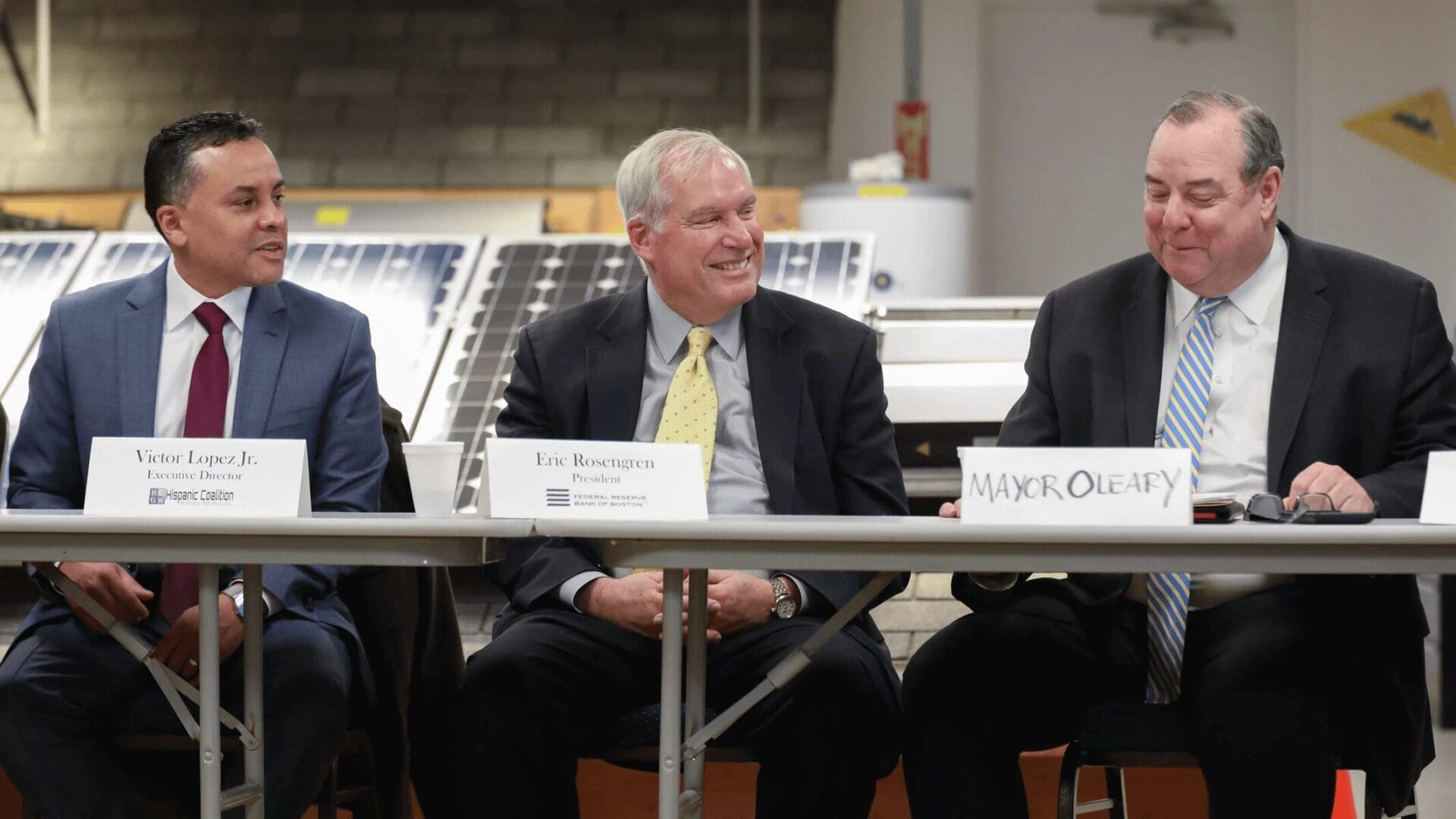 A man sitting at a table with other people.