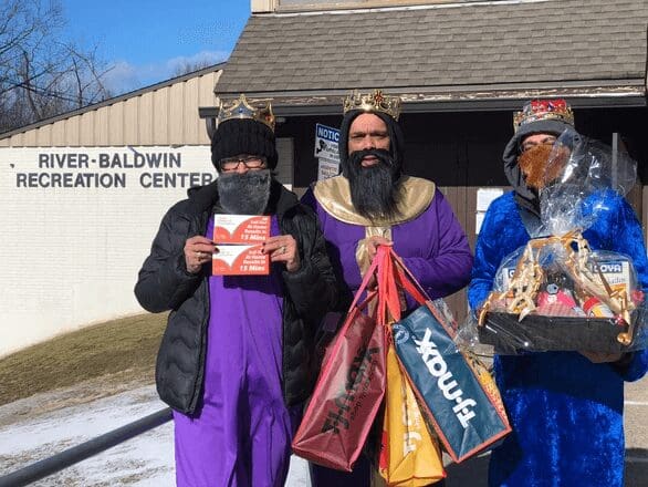 Three men dressed as kings for a charity event.