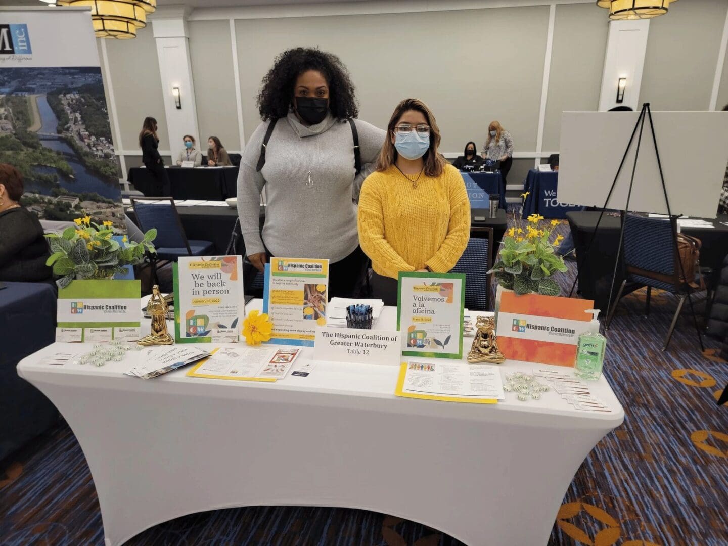 Two women at a Hispanic Coalition table.