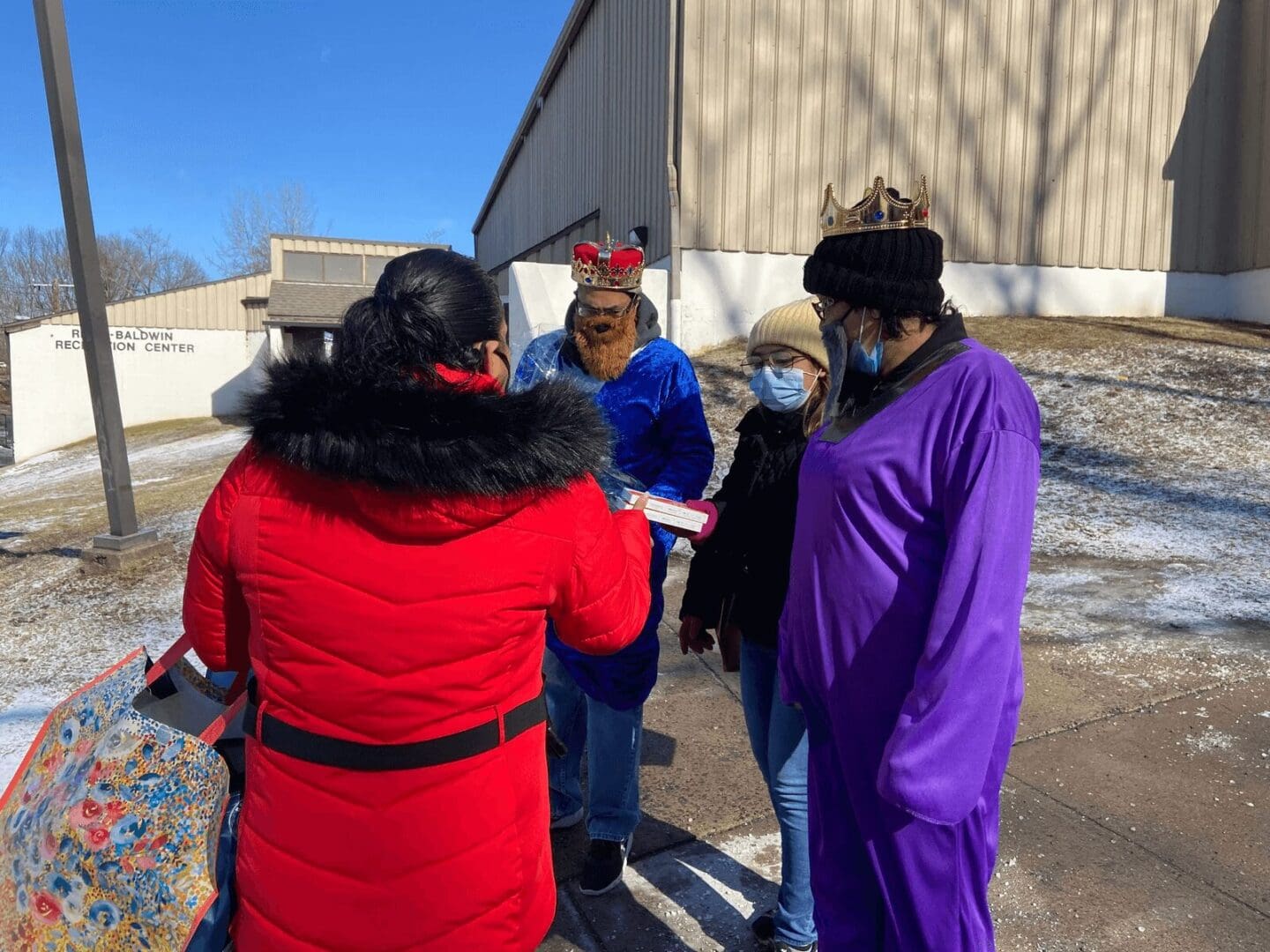 Three people in costumes outdoors.