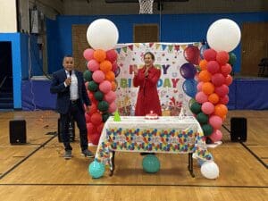 Birthday celebration with balloons and cake.