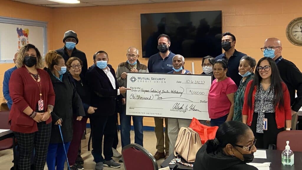 Group of people receiving a large check.