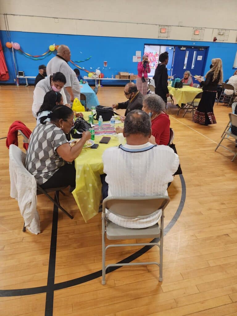 A group of people sitting around tables in a room.