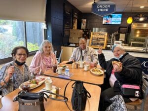 Four people enjoy food at York Street Market.