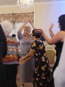 A group of people dancing in a room.