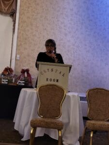 Woman speaking at podium in Crystal Room.