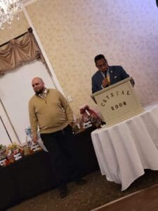 Man speaking at podium in Crystal Room.