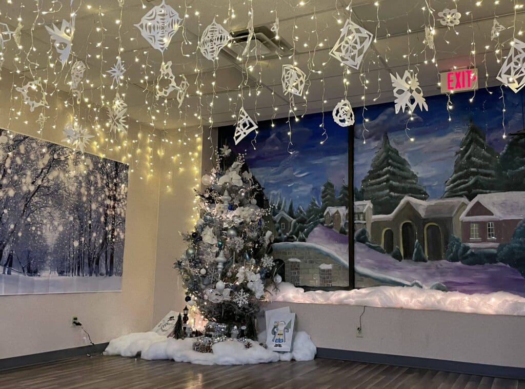 Decorated Christmas tree with snowflakes and lights.