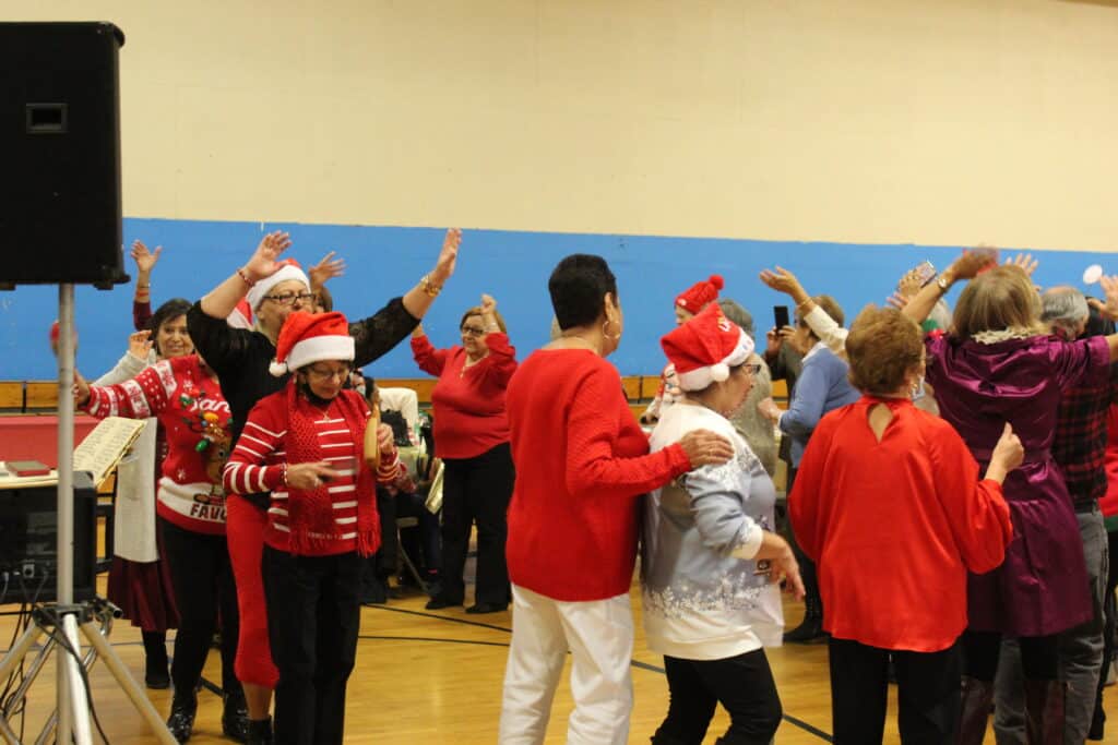 A group of people in red and white clothes dancing.