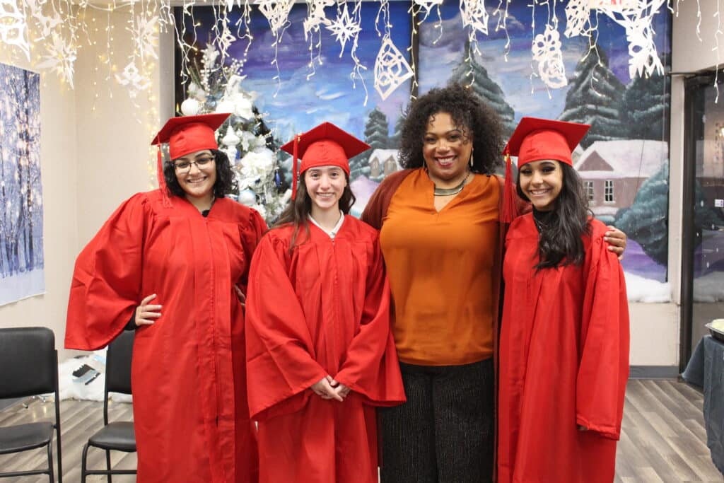 A group of people in graduation gowns posing for the camera.