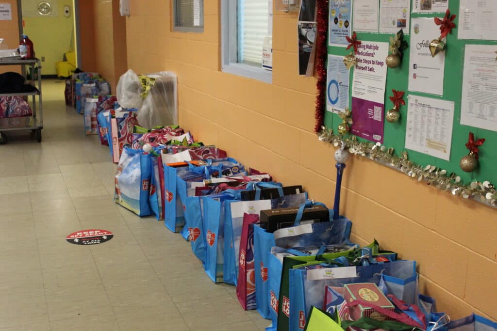 Row of blue bags filled with donations.