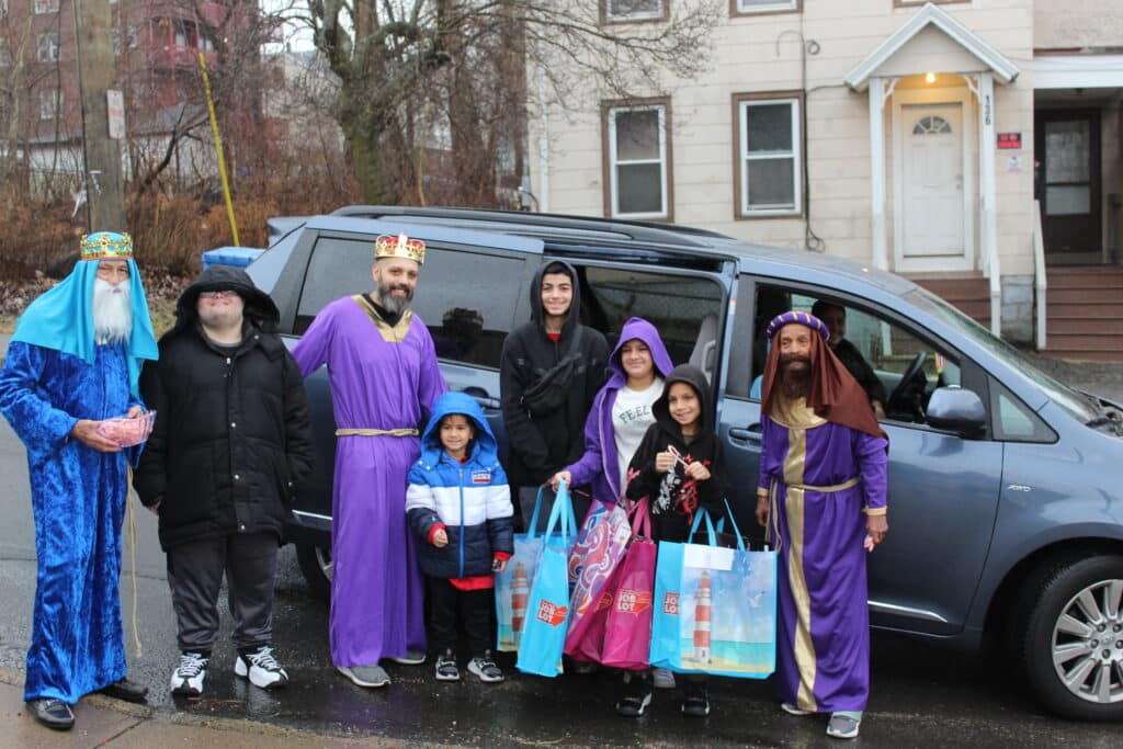 Three wise men and kids by minivan.