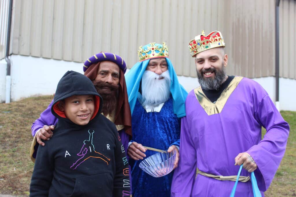 Three wise men and a boy in costumes.