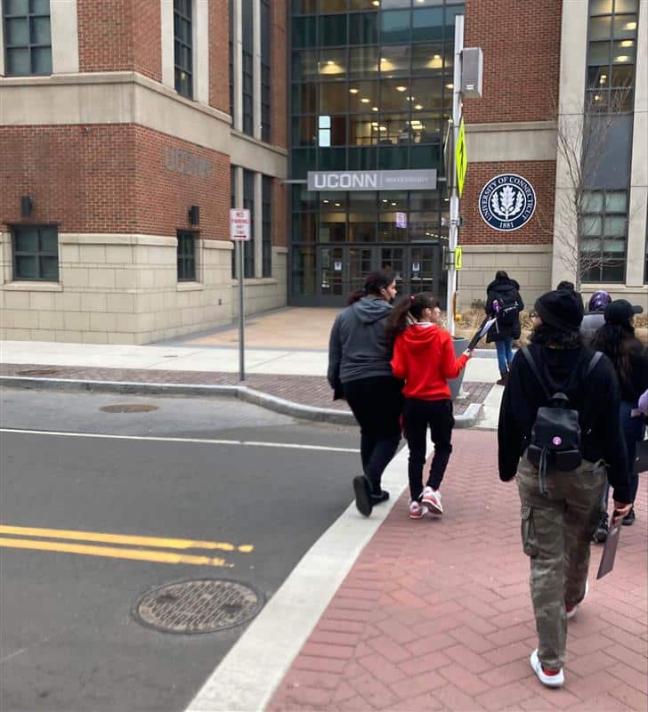 A group of people walking across the street.