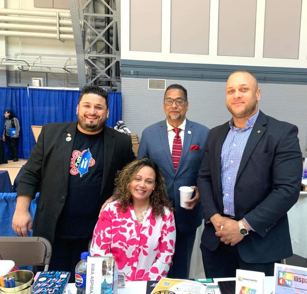 A group of people standing around a table.