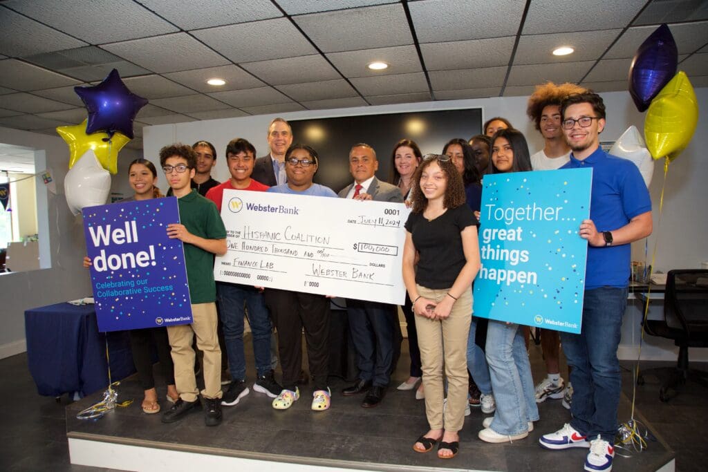 A group of people holding giant checks and signs.