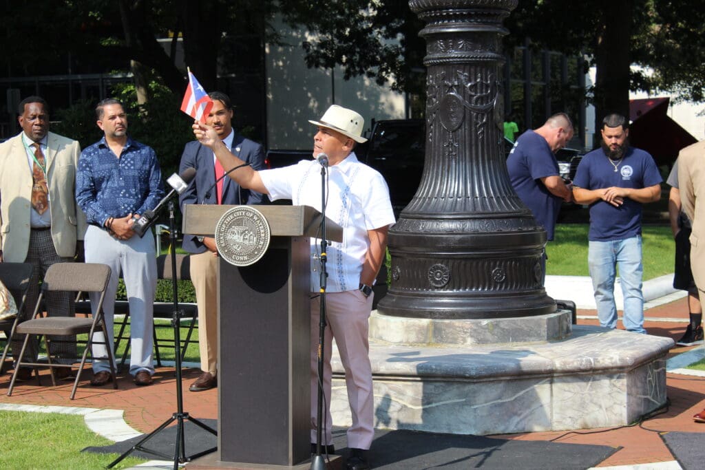 A man standing at a podium with microphones.