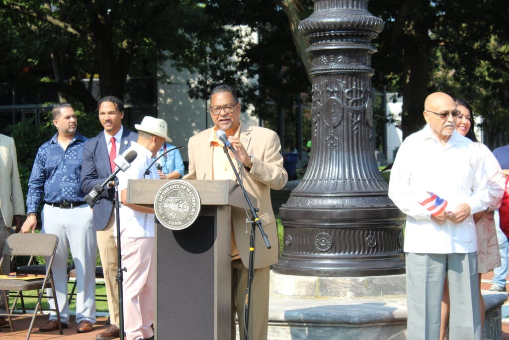 A man standing at a podium in front of a crowd.