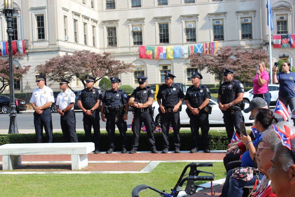 A group of police officers standing in front of a building.