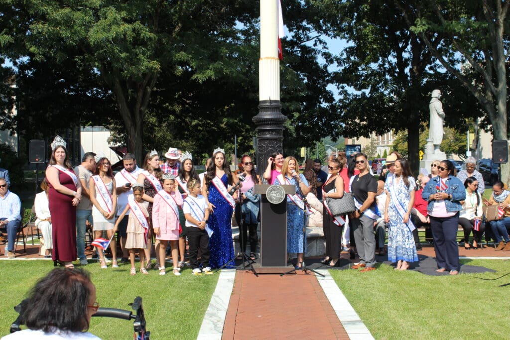 A crowd of people standing around a fire hydrant.