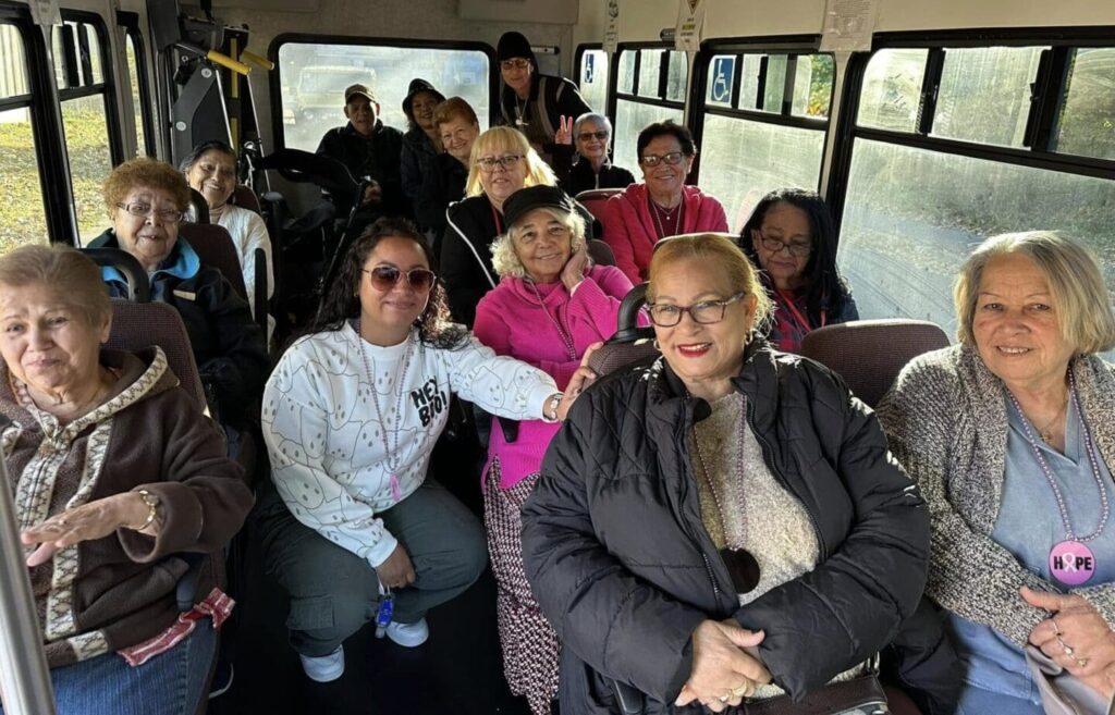 A group of people sitting on the back of a bus.